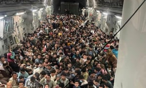 Afghans inside a C-17 Globemaster III, flown from Afghanistan to Qatar