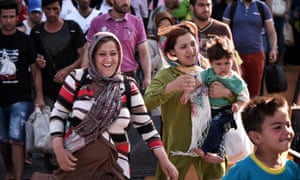 Migrants at the port of Piraeus near Athens disembark from a ferry from the Greek island of Lesbos.