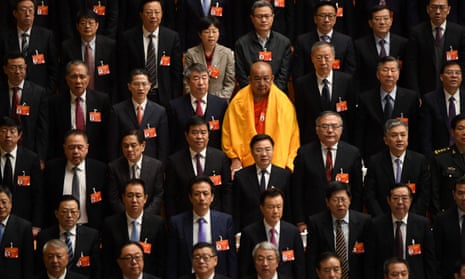 A lone woman is seen among delegates at the National People’s Congress in Beijing