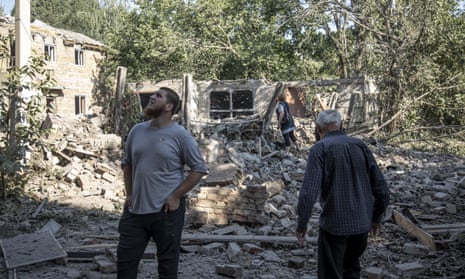 Local civilians inspect the destruction caused by a missile strike in Bakhmut, Ukraine