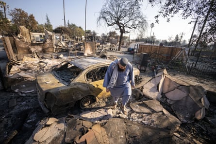 A man walks through debris at a mosque