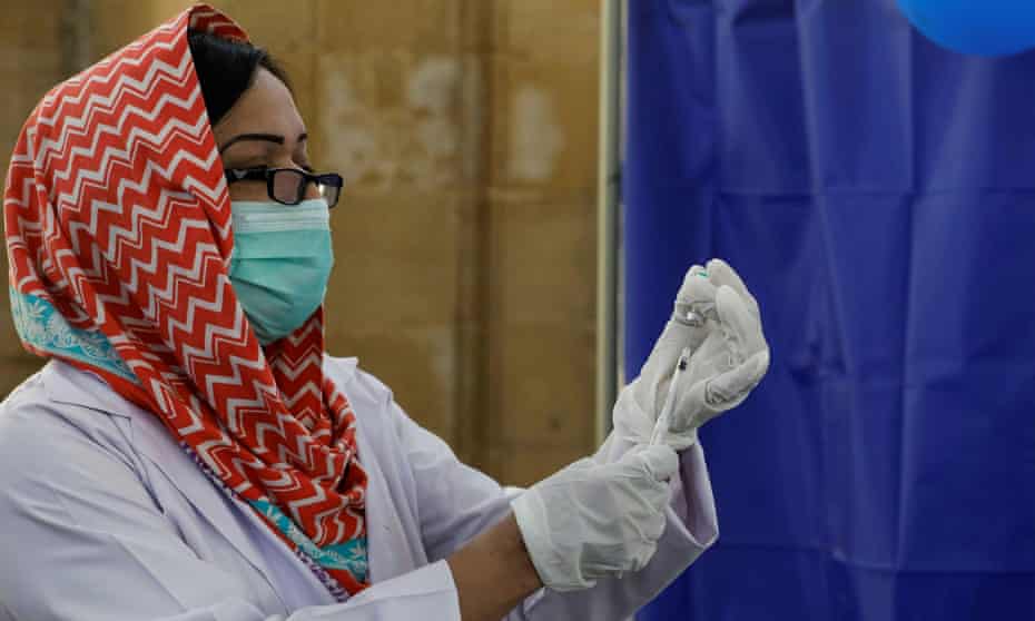 A health worker prepares a dose of Sinopharm’s Covid vaccine in Karachi, Pakistan