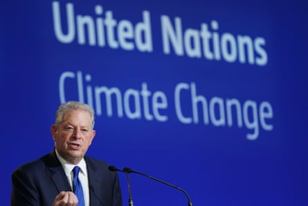 Al Gore speaks in front of a backdrop of the United Nations Climate Change summit.