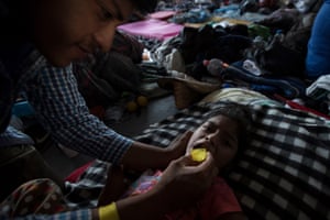 Lesly, who was showing signs of illness, being taken care of by her dad.