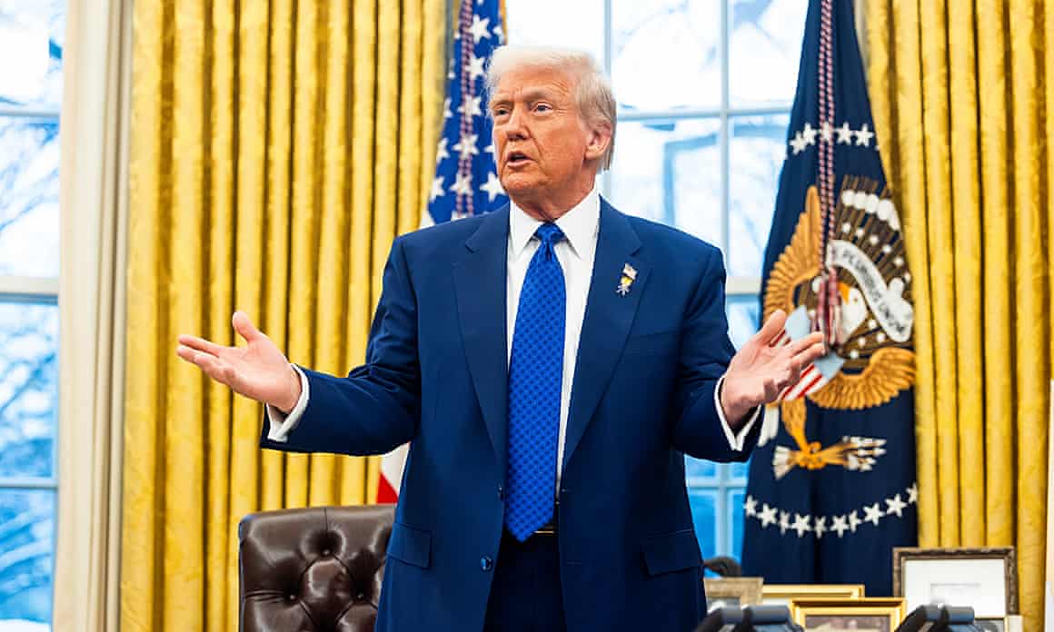 Trump with arms outstretched with presidential and US flags behind next to gold-coloured curtains, and window
