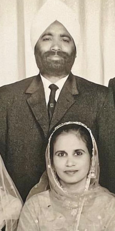 A b&w shot of Savinder in a sari with a man in a turban and a suit and tie standing behind her