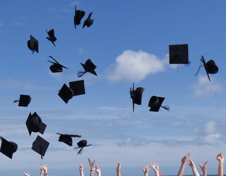 Graduates celebrate by throwing their caps