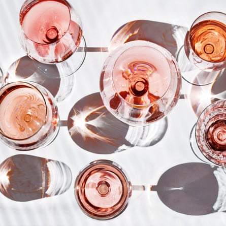 Array of wine glasses filled with rosé, viewed from above.