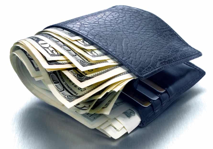 Fat wallet stuffed with dollars on a white background