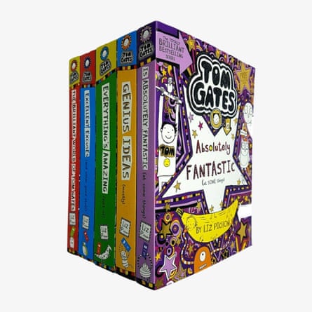 Five Tom Gates book spines stand beside a decorated box with cartoon illustrations and a star