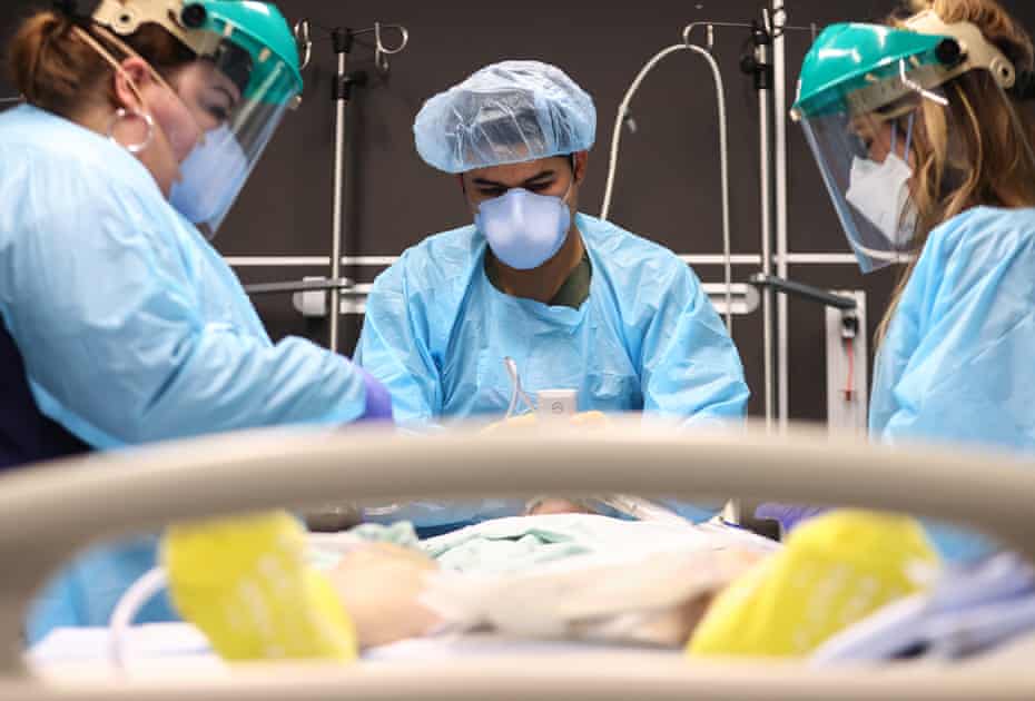 Healthcare workers intubate a Covid patient at Lake Charles Memorial Hospital in Louisiana on 10 August as the state sees record cases.