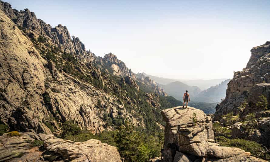 Female hiker standing on viewpoint, Aiguilles de Bavella, Corsica, France