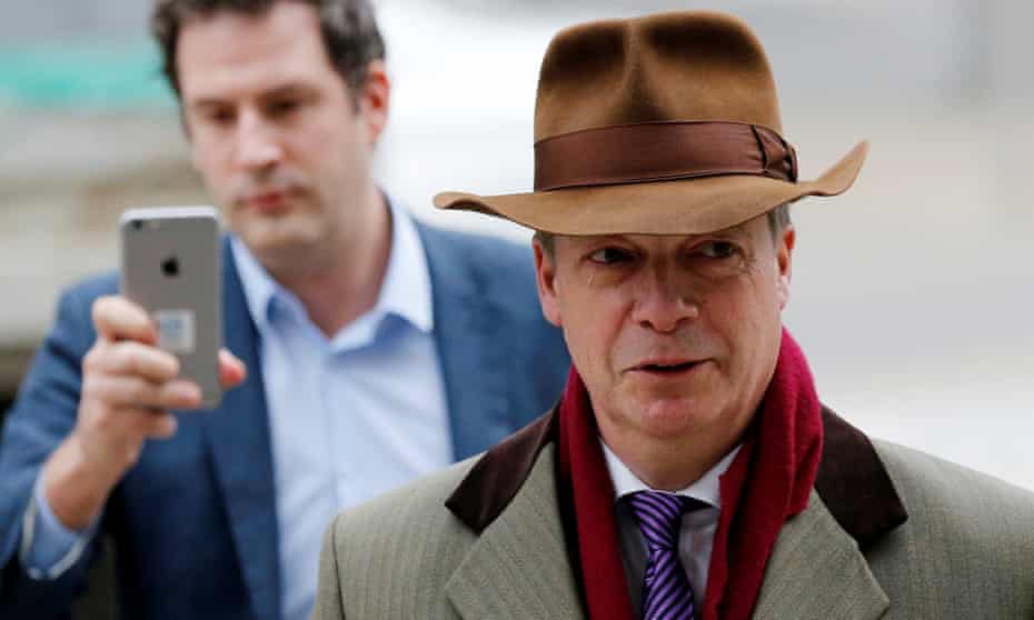 ‘The Brussels Howard Hughes.’ Nigel Farage rocks up to meet Michel Barnier in look-at-me brown fedora.