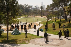 Federal agents ride on horseback during an immigration in a park