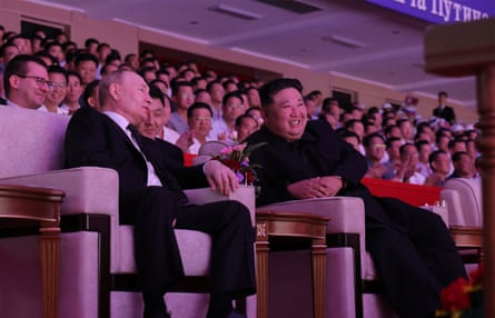 North Korea's leader Kim Jong-un and Russia's President Vladimir Putin watching a performance at the Pyongyang Gymnasium.
