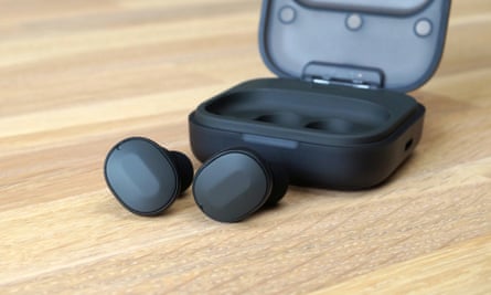 The Fairphone Fairbuds earbuds and case on a table.