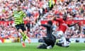 Leandro Trossard of Arsenal scores his team's first goal as Andre Onana of Manchester United and Aaron Wan-Bissaka of Manchester United fail to stop the ball.