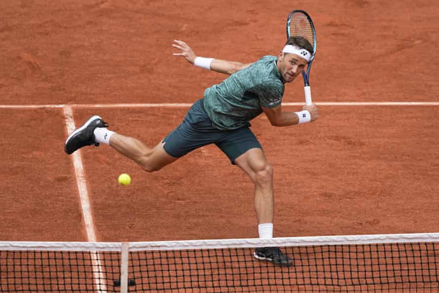 Casper Ruud plays a shot at the net.