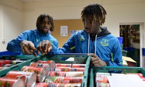 Everton players Alex Iwobi and Moise Kean help out at a foodbank in Liverpool.