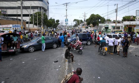 Residents block a street with their cars in a protest at fuel shortages in Port-au-Prince.