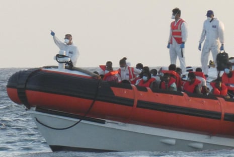 The patrol boat of the Italian Coast Guard is loaded with rescued migrants on its way to desembark at the port in Lampedusa, Italy, on 30 August 2020.