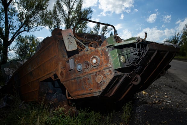 A destroyed Russian amphibious infantry fighting vehicle lies in ruins along a road between Kupiansk and Shevchenkove.