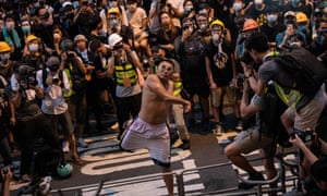 A protester throws an egg at police headquarters in Hong Kong on Sunday.