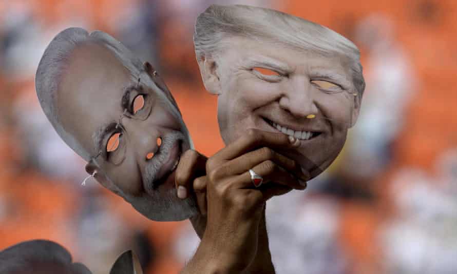 Indians hold masks of Donald Trump and Narendra Modi at the Sardar Patel Gujarat Stadium in Ahmedabad in February 2020.