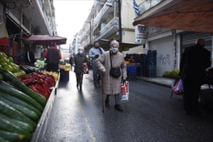 Shoppers pick up groceries at a street market in Thessaloniki, Greece.
