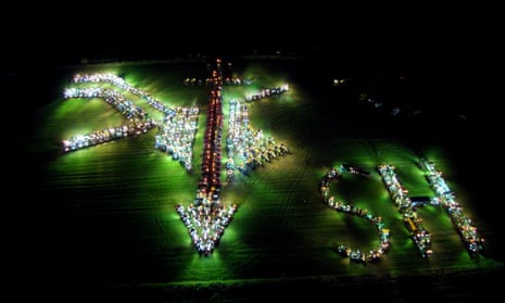 Farmers in Oldenswort use their tractors in a field at night with lights on to recreate plough and sword symbol of a violent 1920s protest movement.