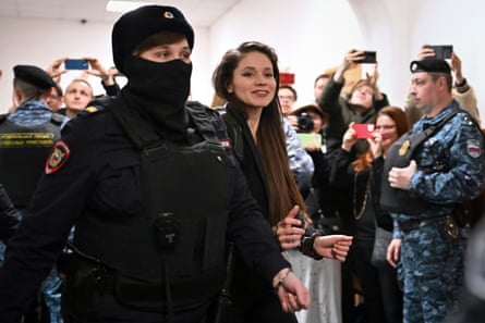 Journalist Antonina Favorskaya, who filmed the last video of Russian opposition politician Alexei Navalny before he died, is escorted into a Moscow courtroom last month.