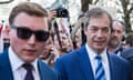George Cottrell, wearing sunglasses, joins Nigel Farage on a Leave Means Leave march in London in 2019.