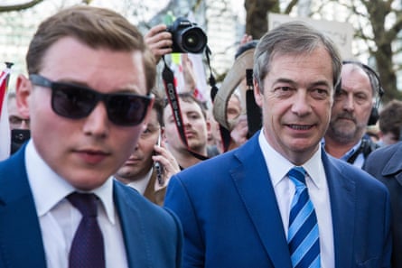 George Cottrell, wearing sunglasses, standing next to Nigel Farage at a political march