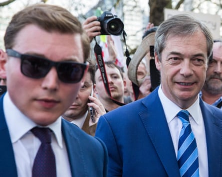 George Cottrell and Nigel Farage walking through a crowd