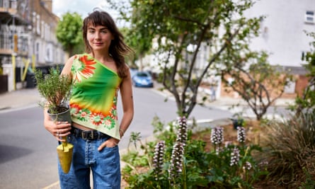 A woman holding a plant.
