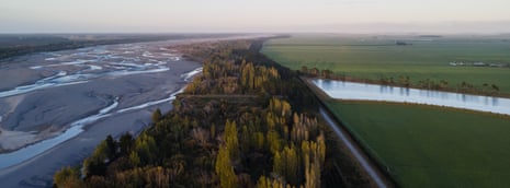 Water from a river runs into a nearby farming irrigation pond