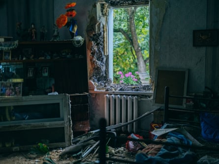 The interior of a house with debris of shattered glass and furniture on the floor