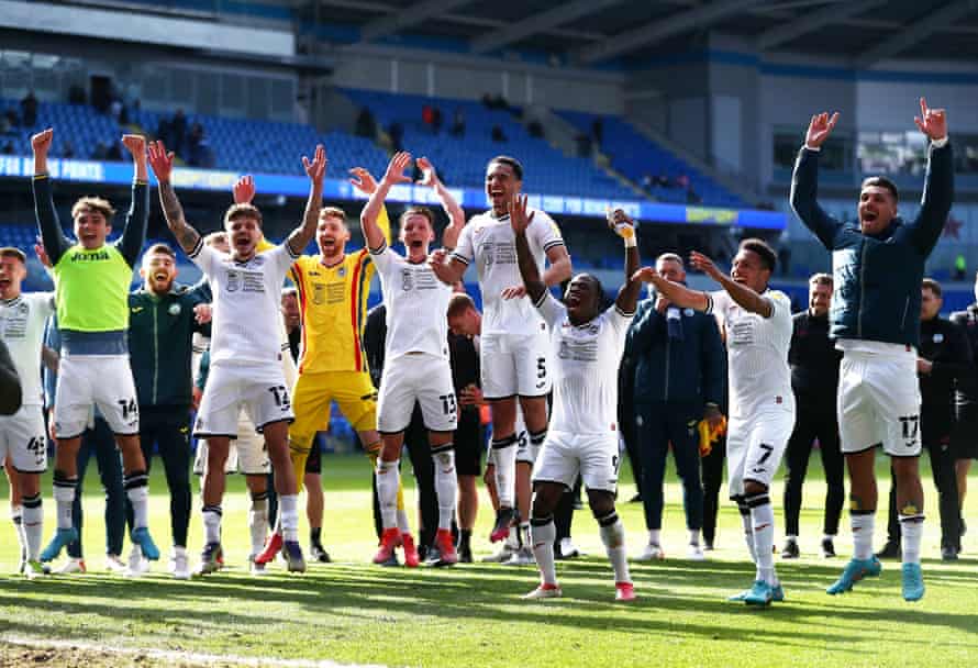 Swansea’s players celebrate with their fans after the game.