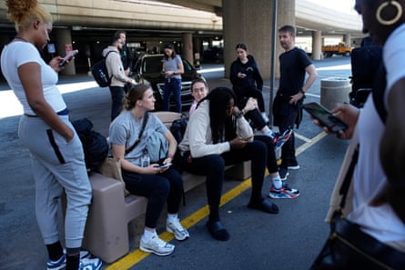 Players and staff of the New York Liberty wait to board buses at Harry Reid International Airport last June in Las Vegas.