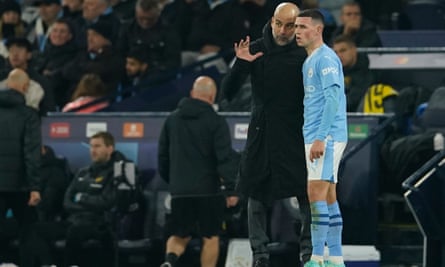 Manchester City's head coach Pep Guardiola talks to Manchester City's Phil Foden during the group G Champions League soccer match between Manchester City and Young Boys