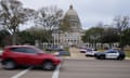 Traffic rolls past the state capitol in Jackson, Mississippi, as police respond to a bomb threat. 