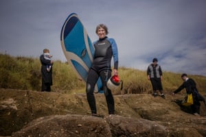 Gwyn Haslock, Praa Sands, Cornwall, August 2016 Haslock, 71, has surfed every day on Cornish beaches near her home for the past forty years. This was taken after a surf session at Praa Sands. “I have no idea who the Orthodox Jewish family were,” says Guardian photographer Sarah Lee. “They appeared from the dunes after I had asked Gwyn to pose on the rocks. They moved about her for a few moments entirely absorbed in their own family, unaware of us and then moved on. It was a wonderfully incongruous, and very British, moment.”