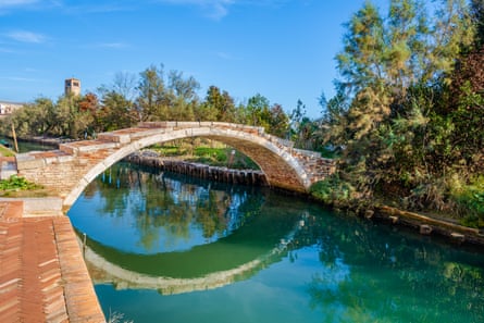 Old curved bridge over a canal