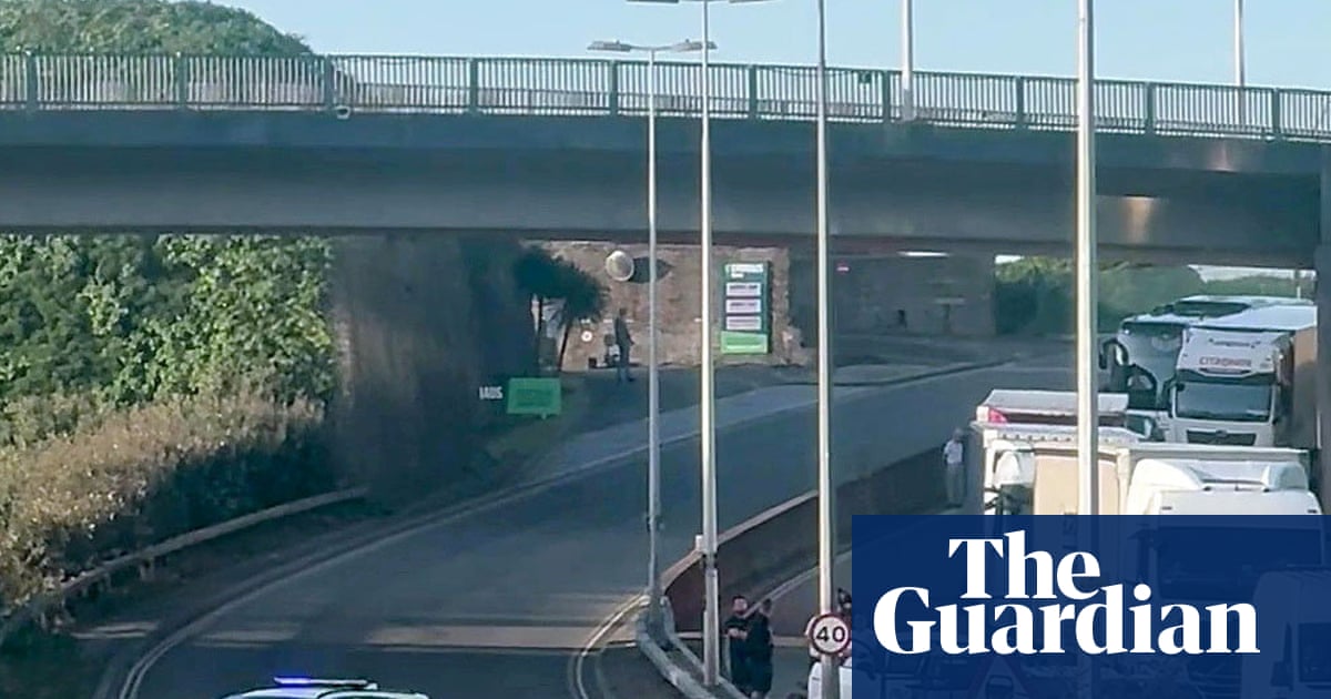 Black-clad protesters in balaclavas block road at port of Dover in Kent