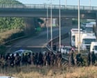 Black-clad protesters in balaclavas block road at port of Dover in Kent