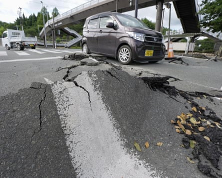 A car passes a damaged section of road