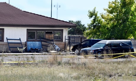 A hearse and debris can be seen at the rear of the Return to Nature funeral home in Penrose, Colorado.