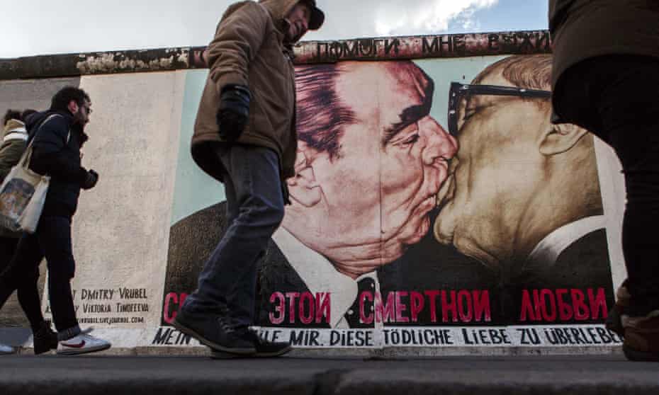 A mural on a remnant of the Berlin Wall depicts Leonid Brezhnev kissing former communist East German leader Erich Honecker.
