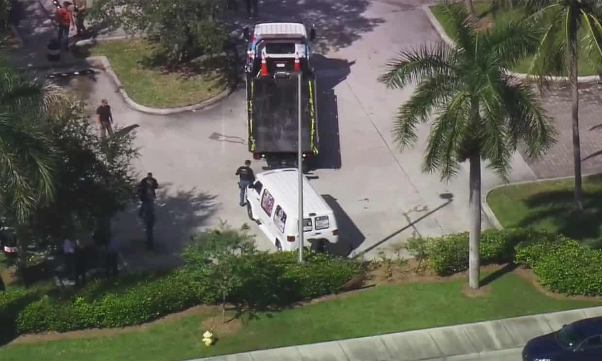 FBI agents and police officers prepare to load a suspicious van parked in Plantation on to a flatbed tow truck.