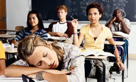 Teenage Girl Sleeps at Her Desk in a Classroom of Secondary School Students<br>Teenage Girl Sleeps at Her Desk in a Classroom of Secondary School Students - stock photo